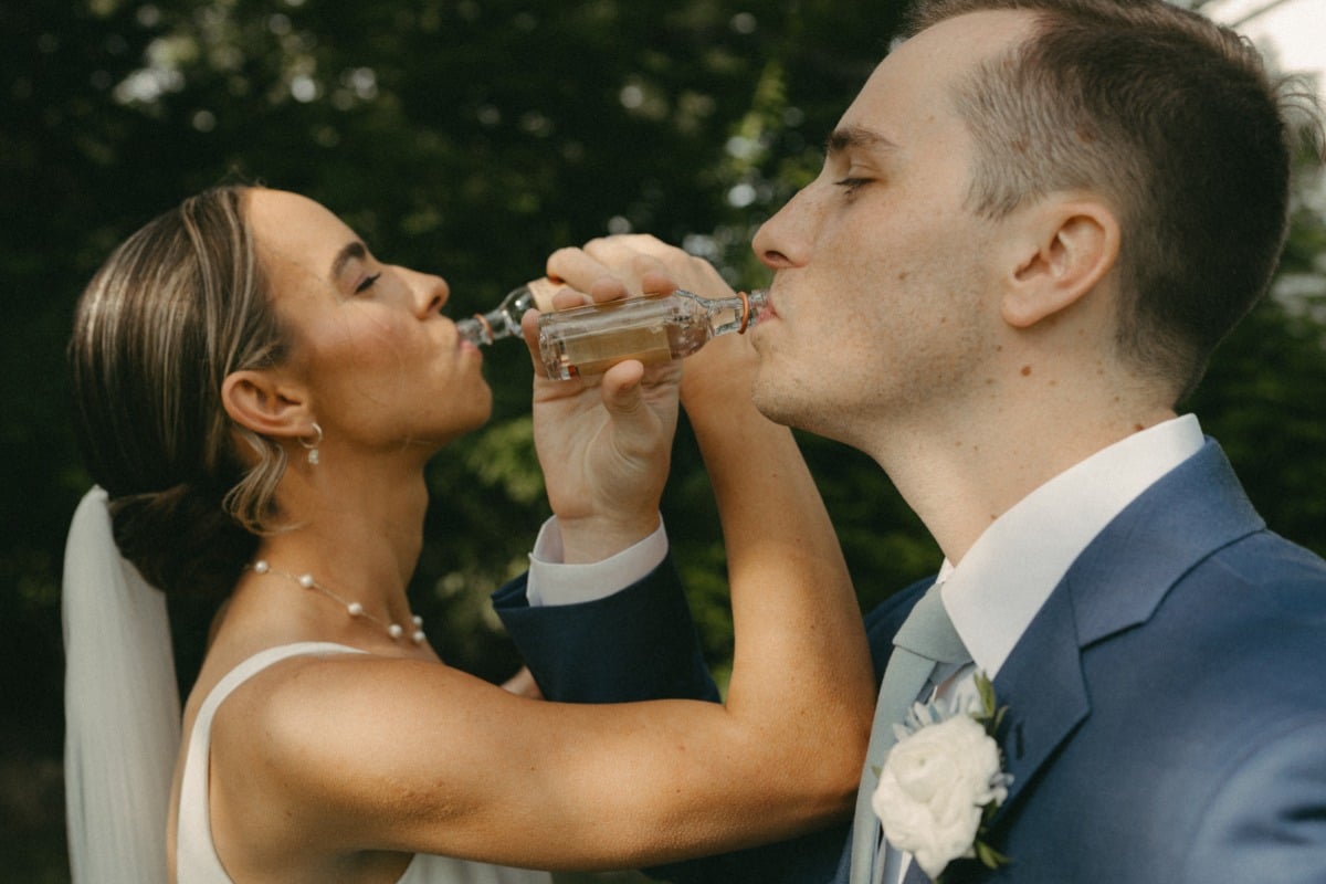 bride and groom taking tequila shot before wedding