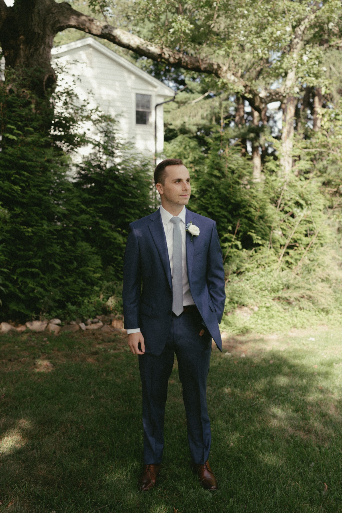 groom in blue suit for garden wedding