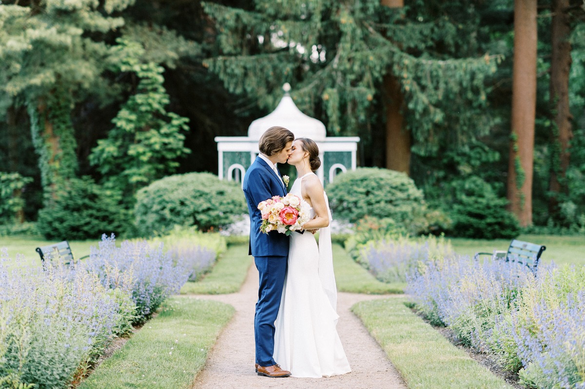 bride and groom kiss in garden