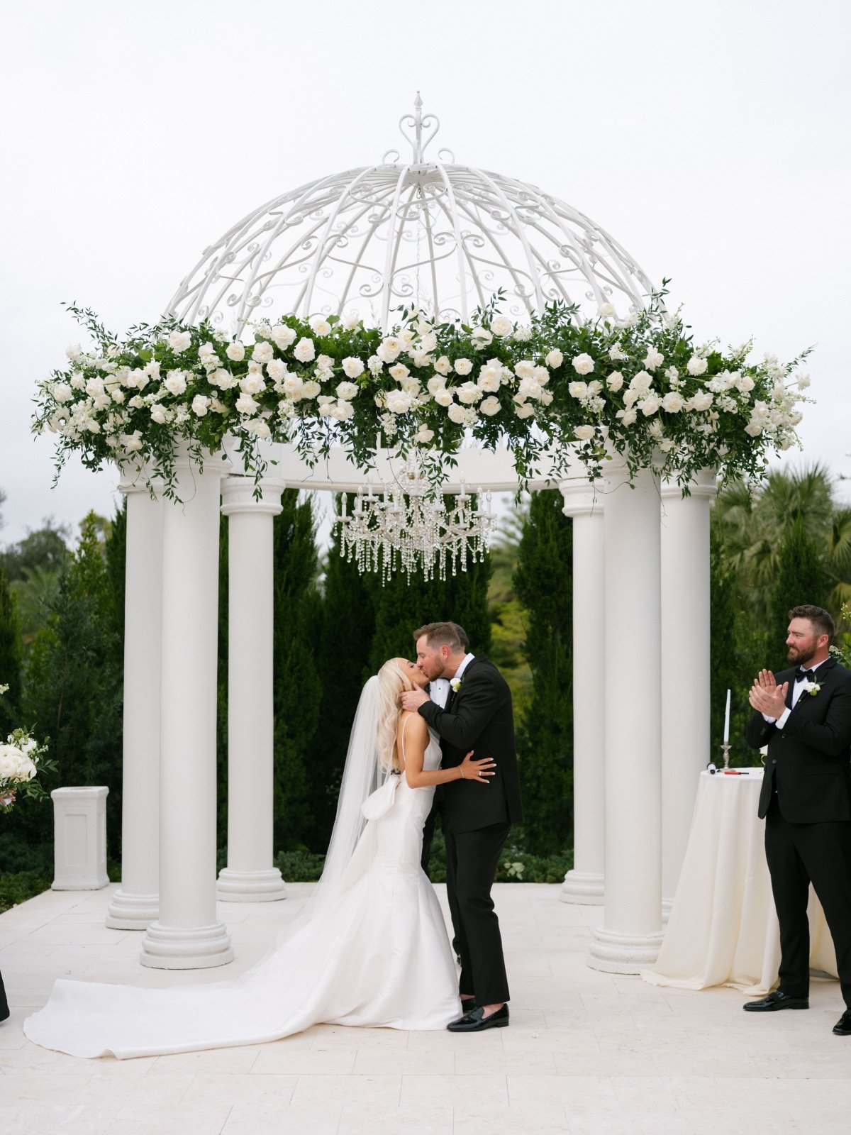 floating white rose and greenery installation with chandelier