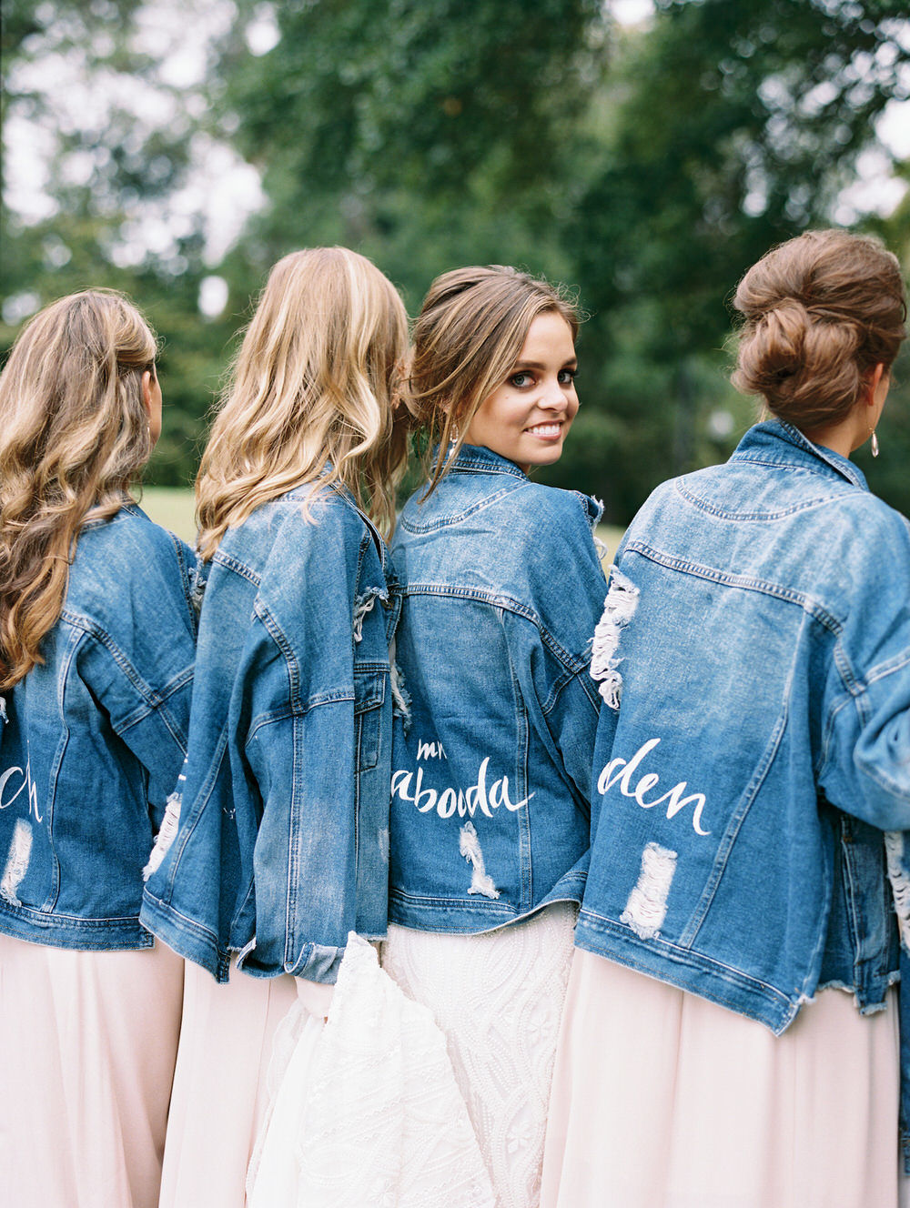 bride and her bridesmaids wearing custom jean jackets