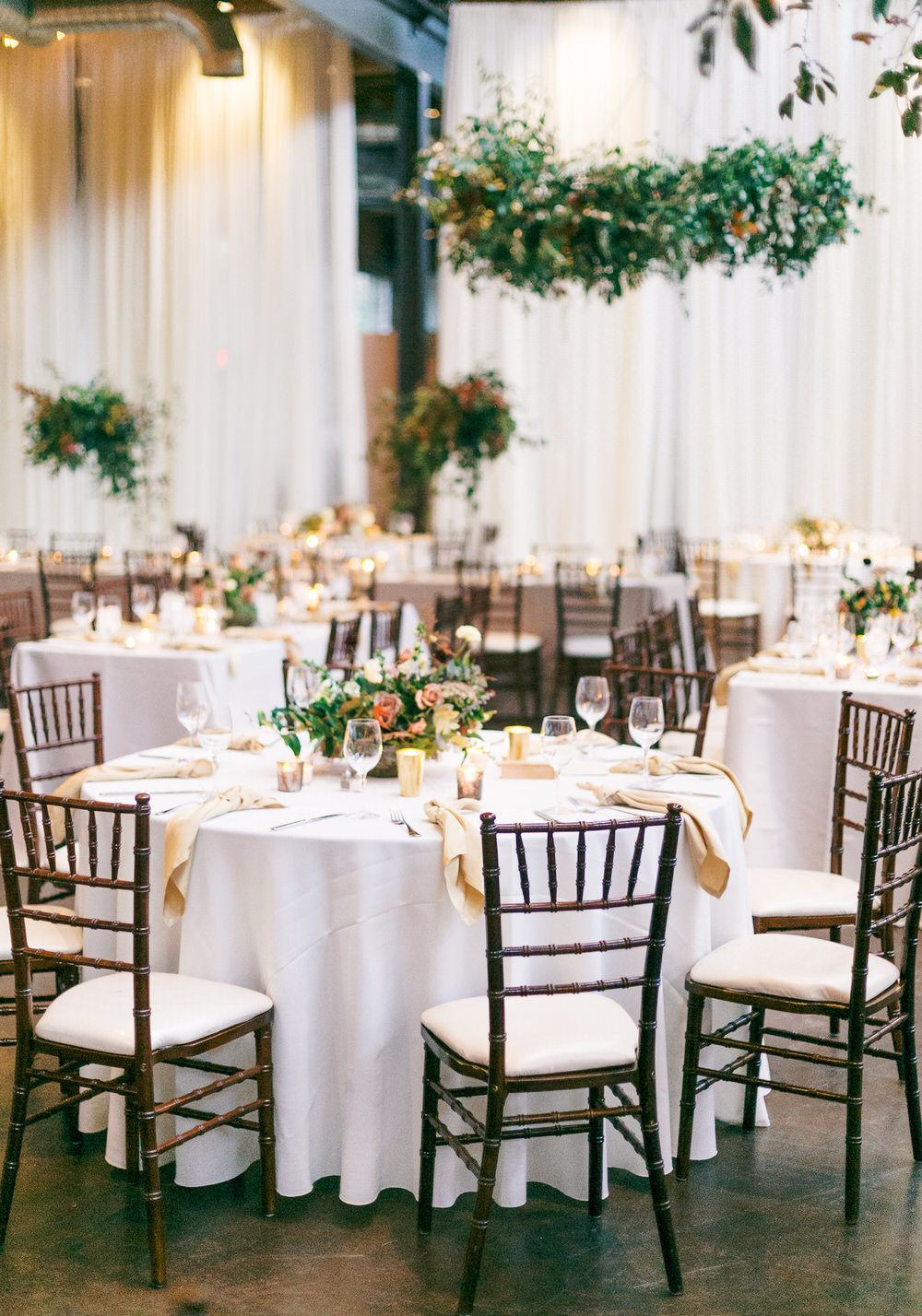 reception setup with lush greenery floral installation