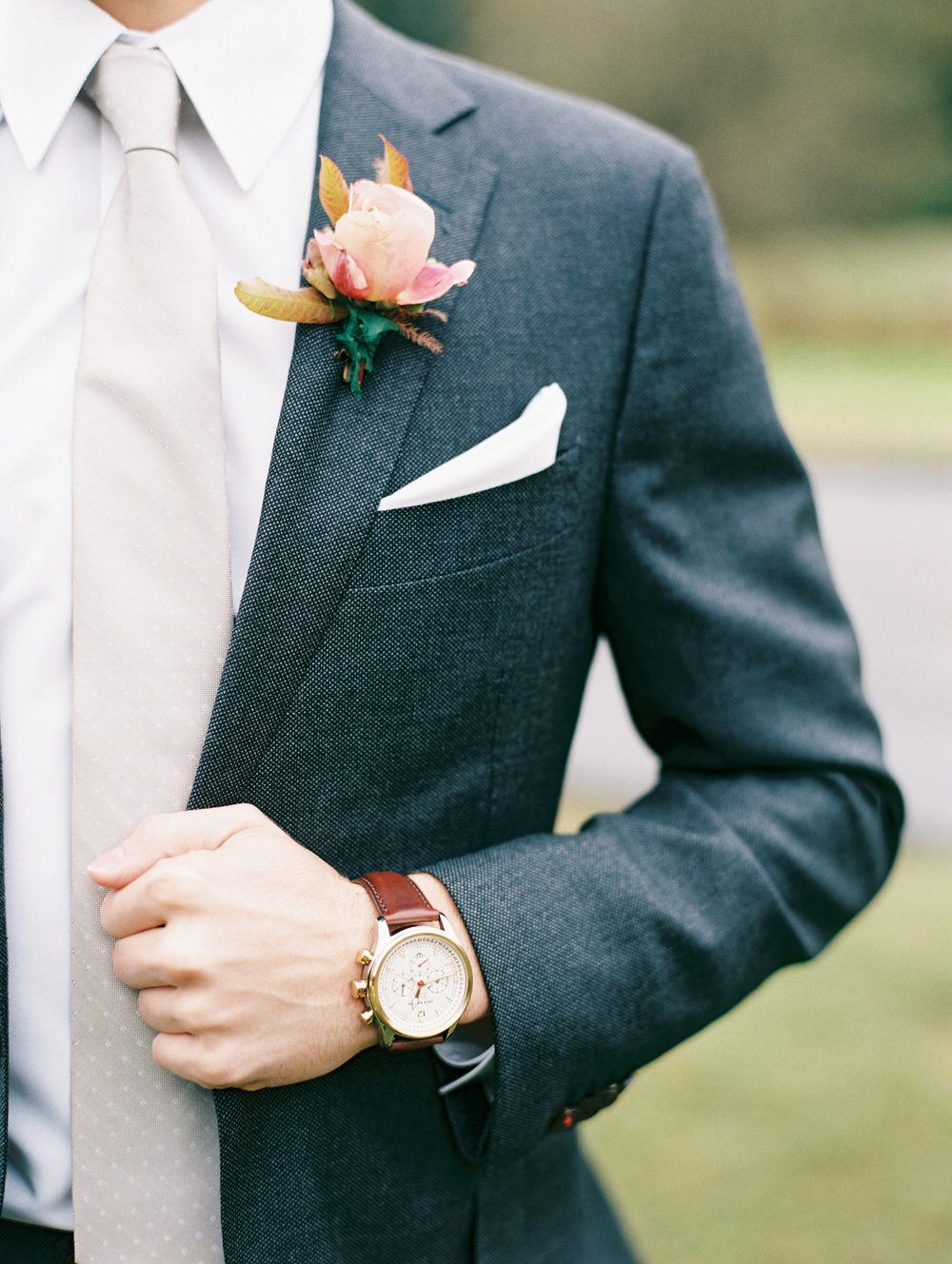 groom details showcasing his watch and boutonniere