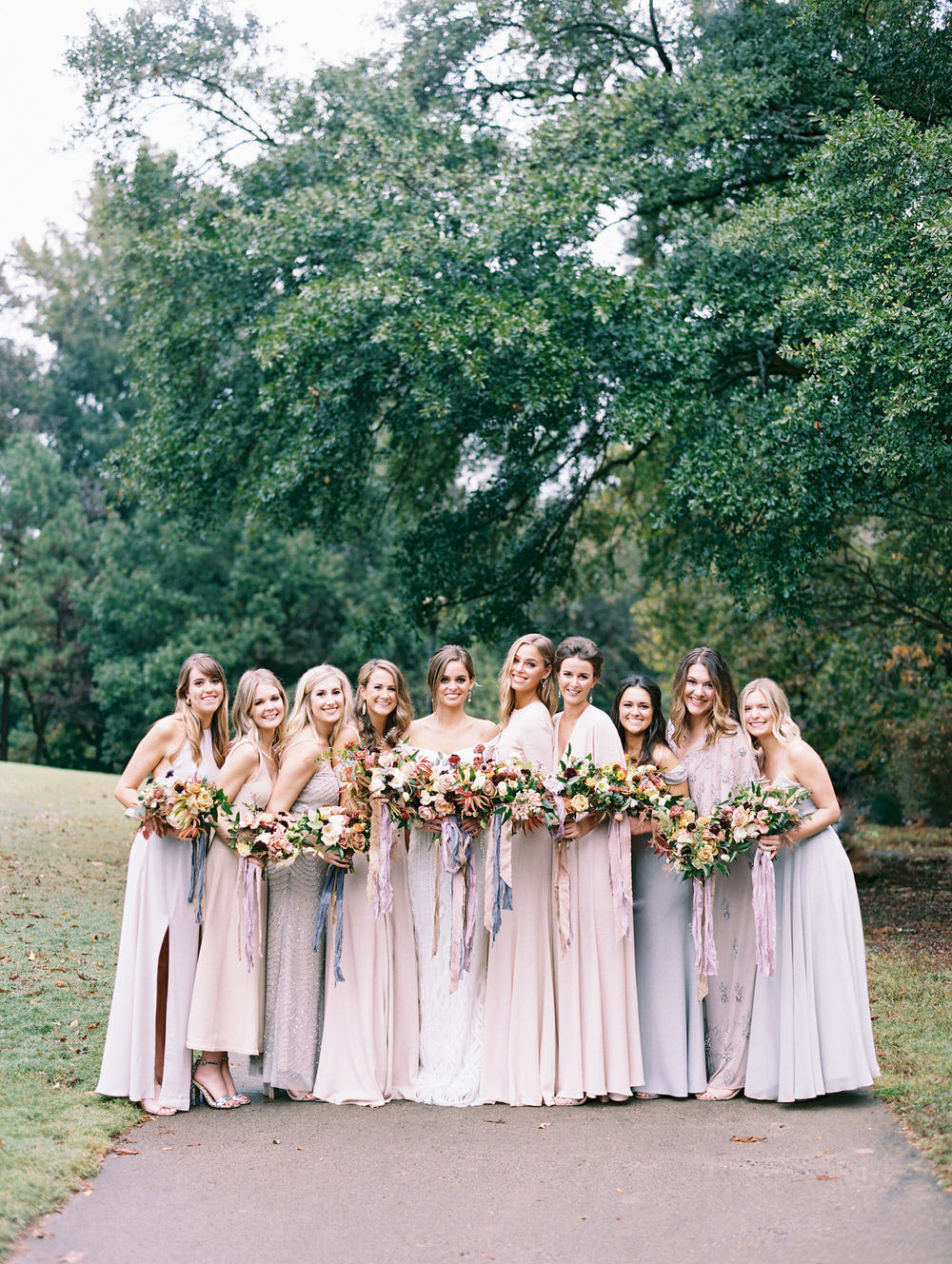 bride with her bridesmaids in their elegant dresses