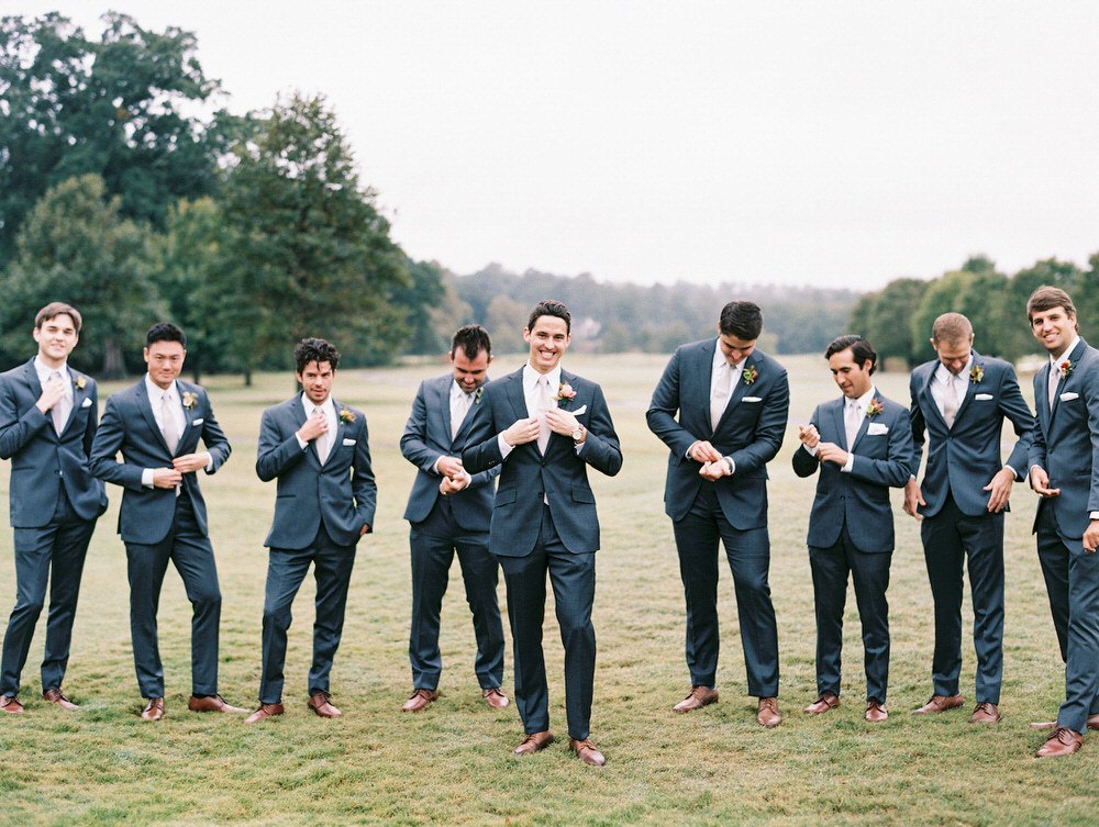 groom with his groomsmen laughing