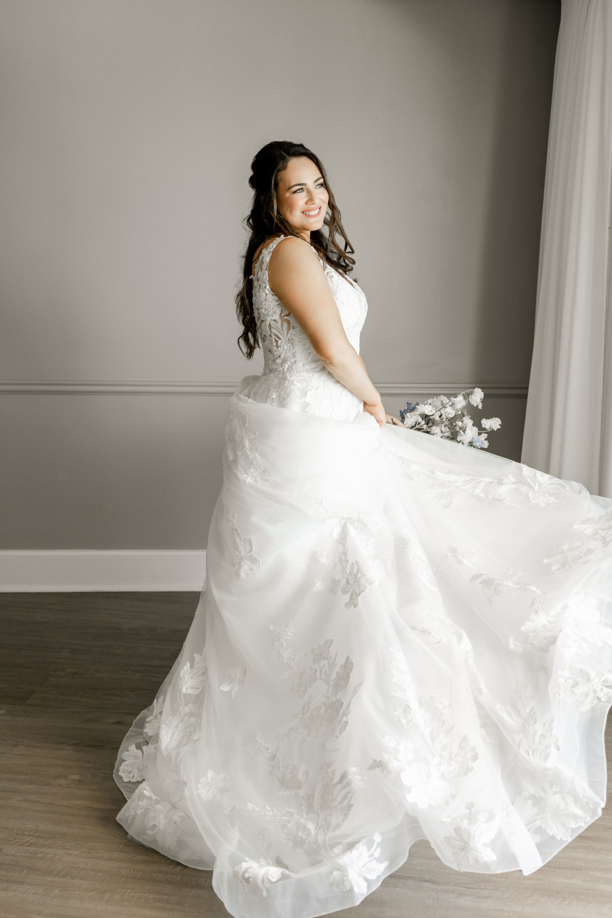 bride twirls in lace a line wedding gown