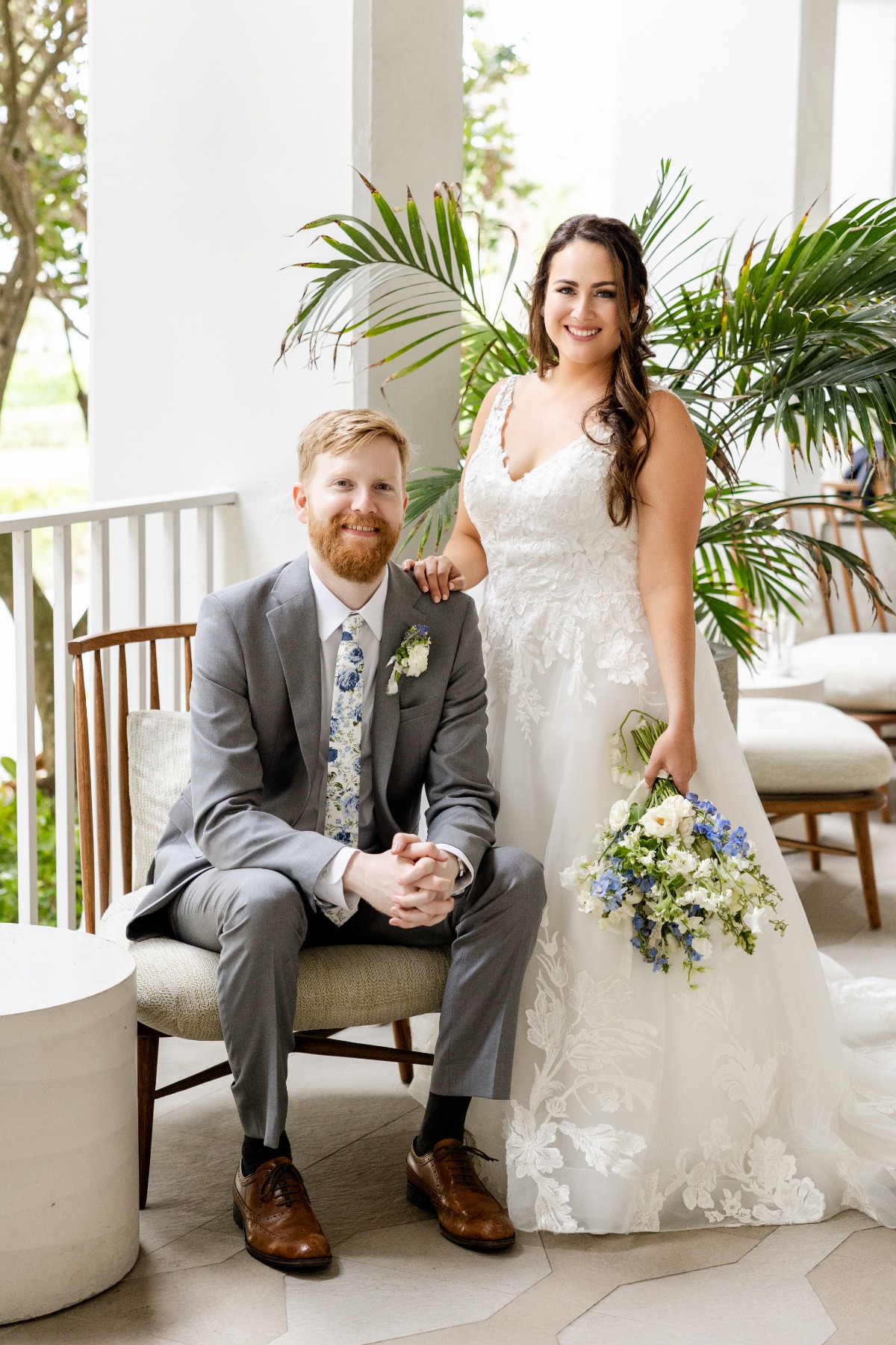 bride in lace gown and groom with blue and white floral tie