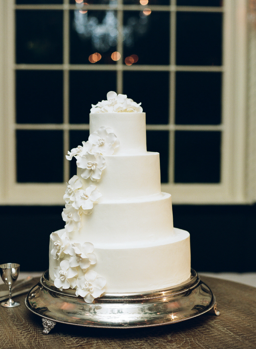 all white wedding cake with sugar flowers