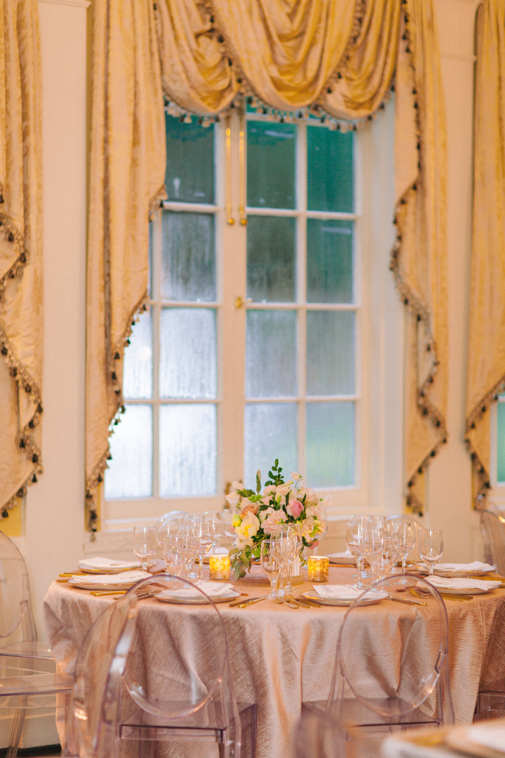 reception tablescape with silk linens and ghost chairs