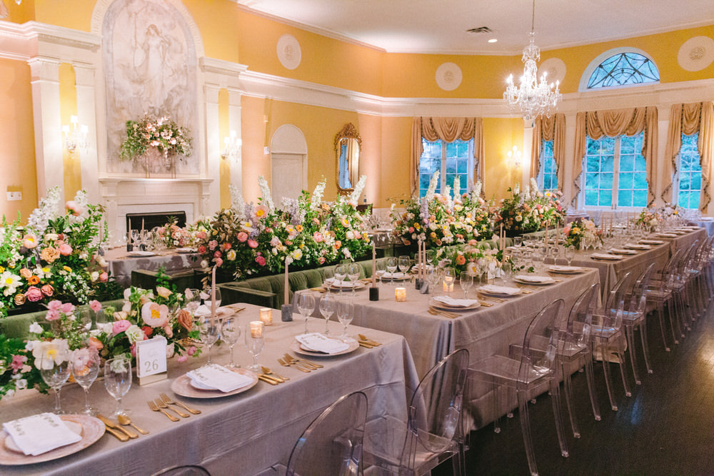 long tables with velvet forest green couches