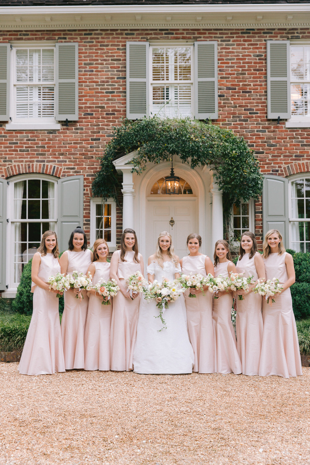 bride with her bridesmaids in floor length blush dresses