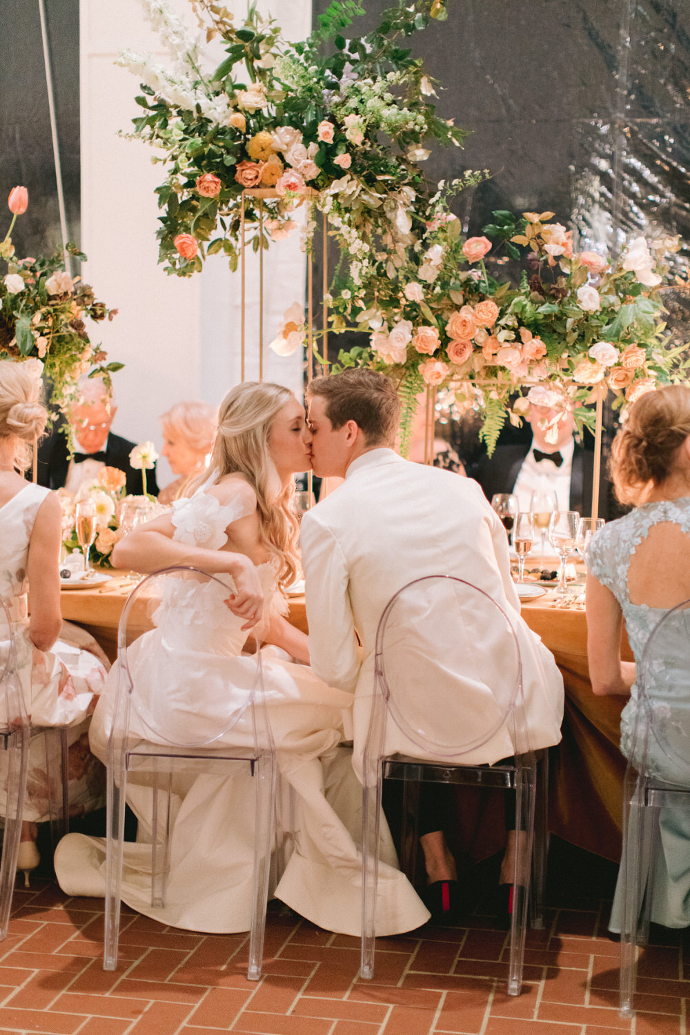 bride and groom steal a kiss during their luxe reception