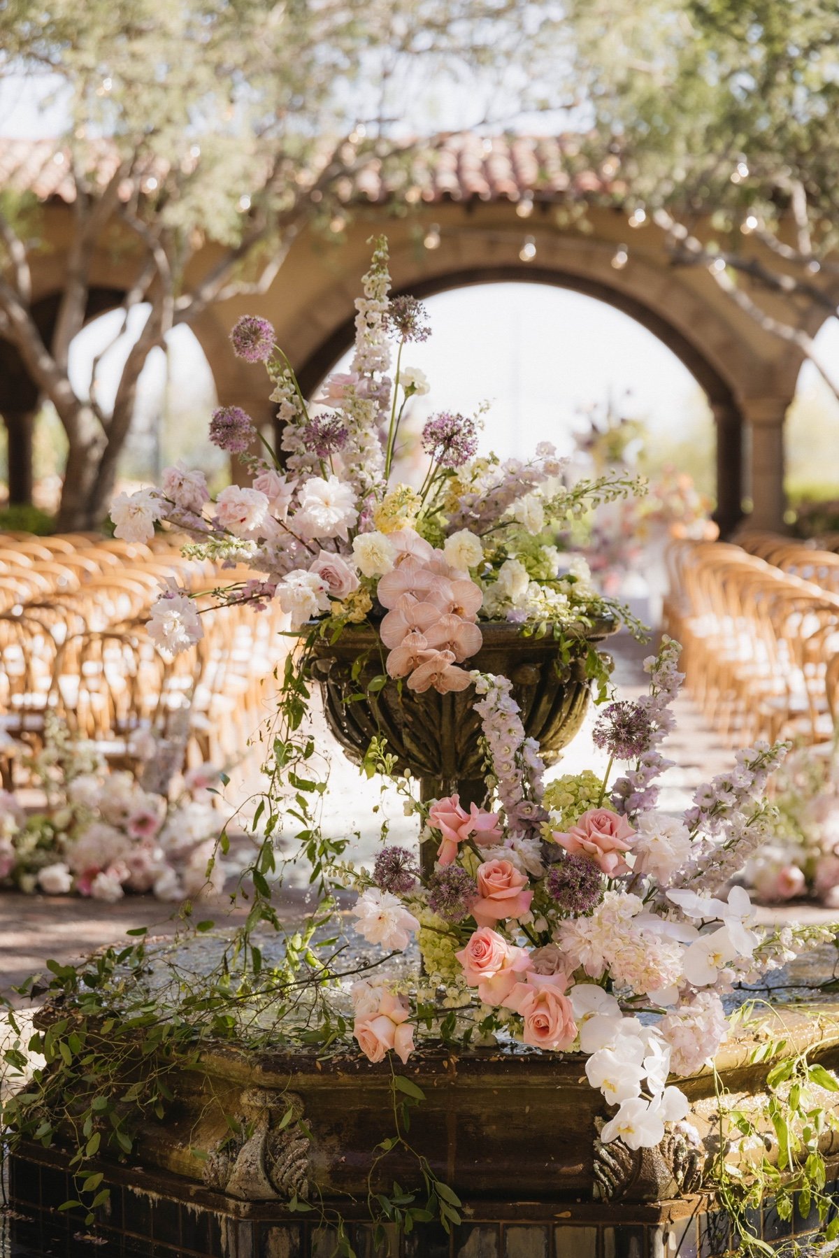 pastel wedding flower arrangements in a fountain for ceremony