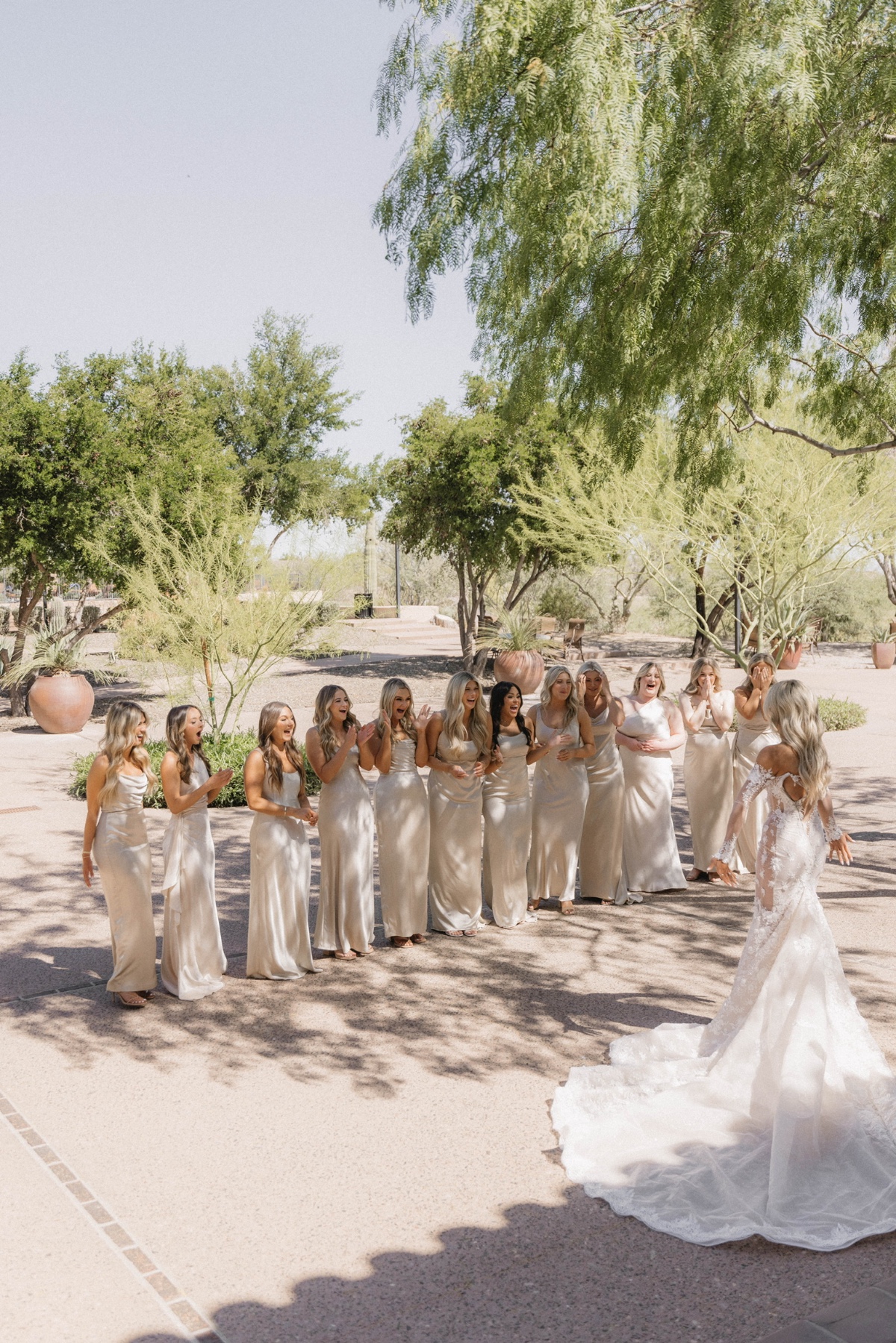 bridesmaids in ivory dresses with bride in white