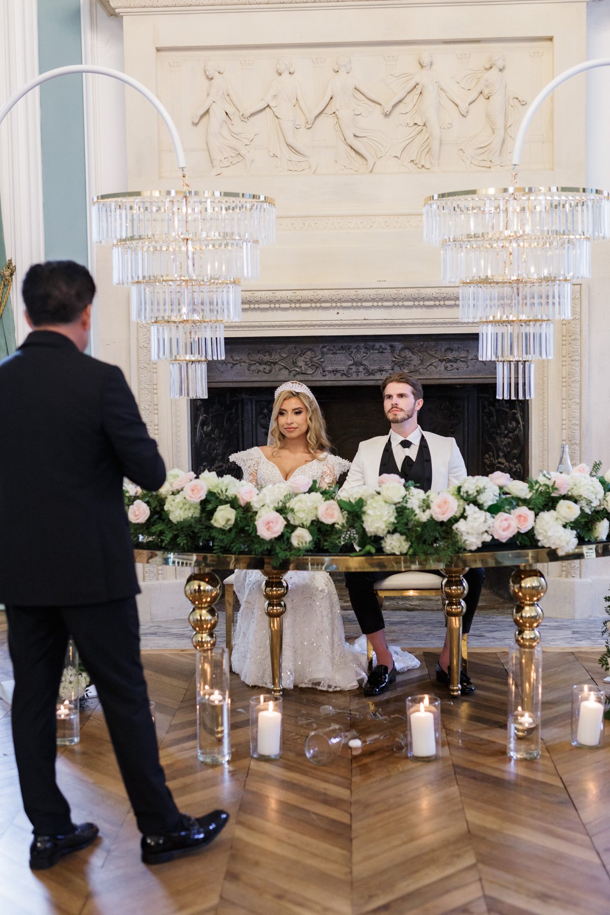 bride and groom at sweetheart table at ballroom reception