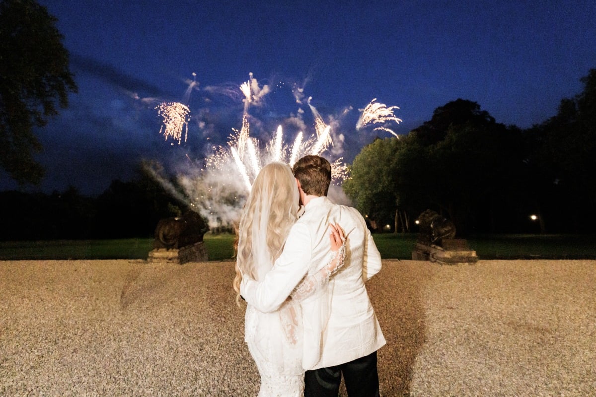 bride and groom watch fireworks at wedding in paris