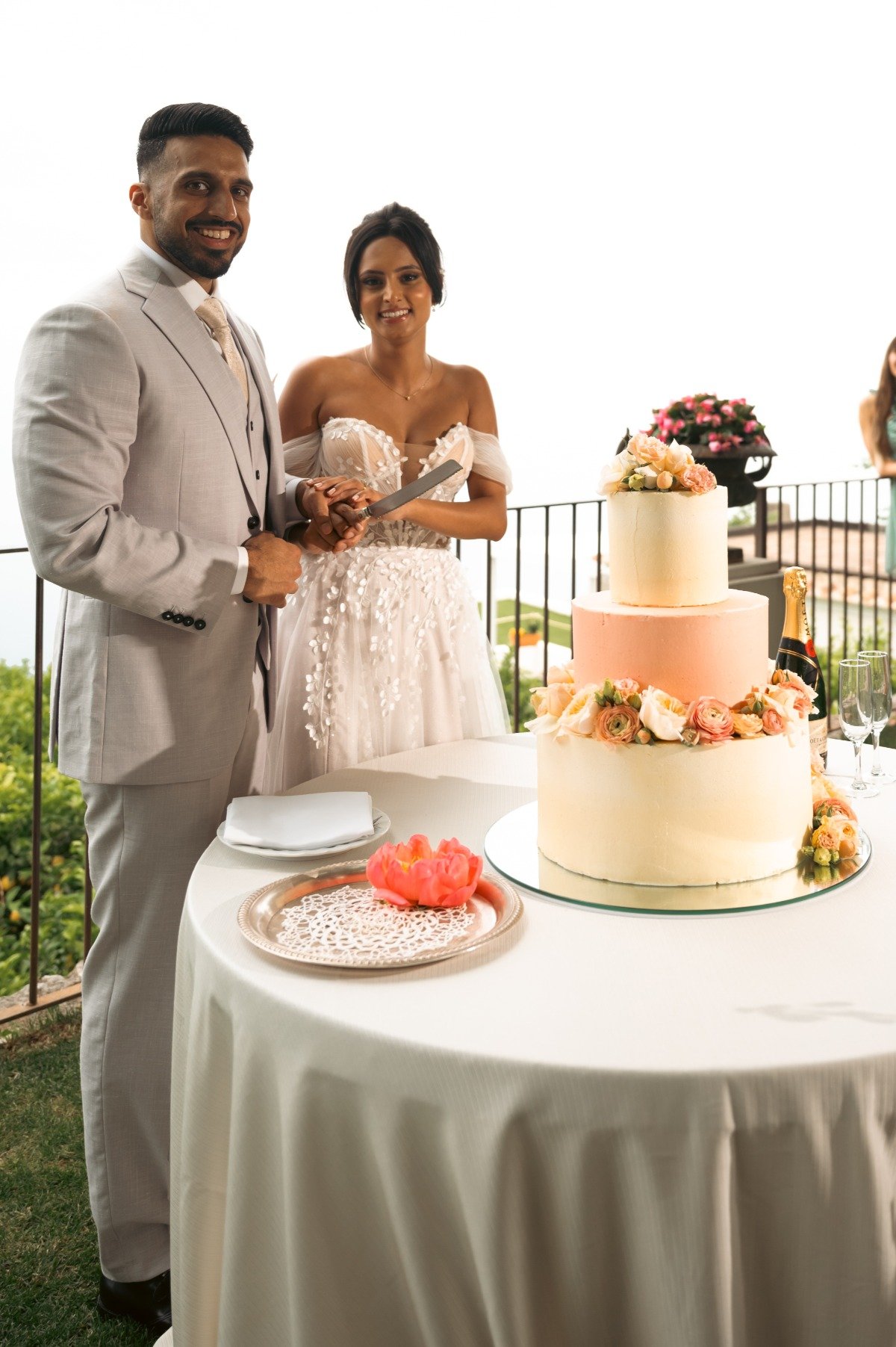 peach and ivory wedding cake with fresh flowers