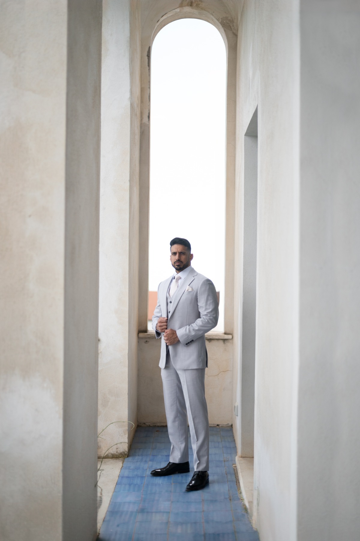 groom in three piece gray suit for wedding