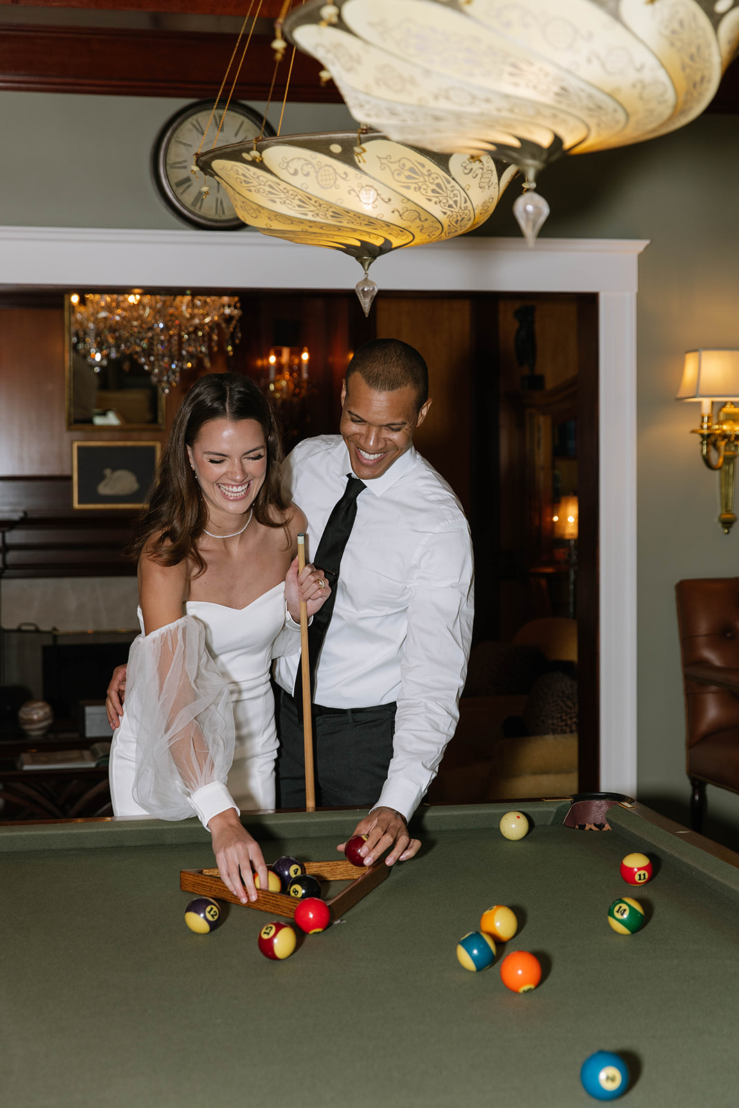 bride and groom playing pool