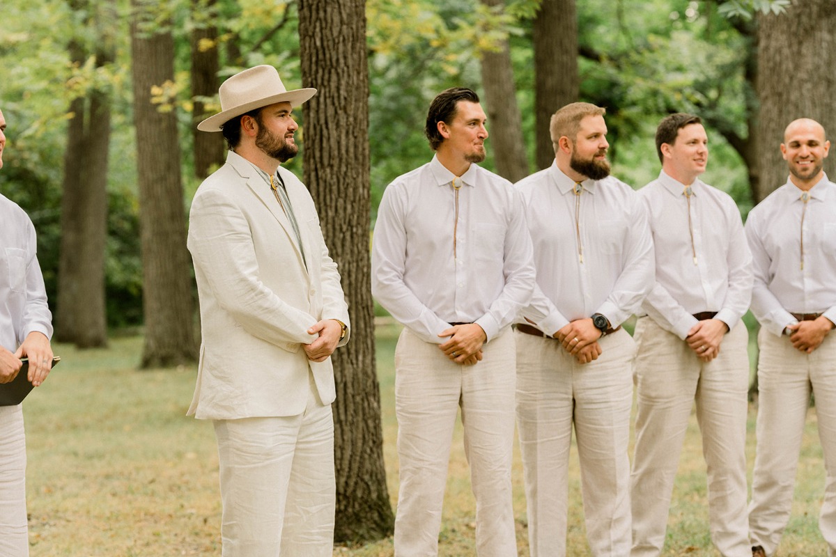 groom and groomsmen in tan and white linen suits