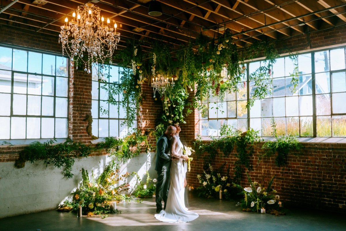 industrial wedding ceremony with greenery