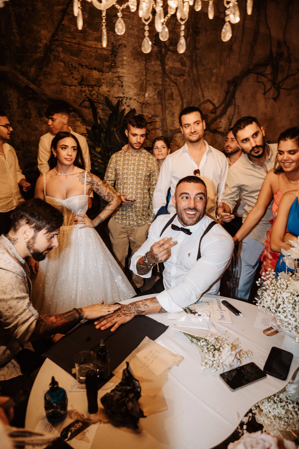 groom gets tattoo at wedding