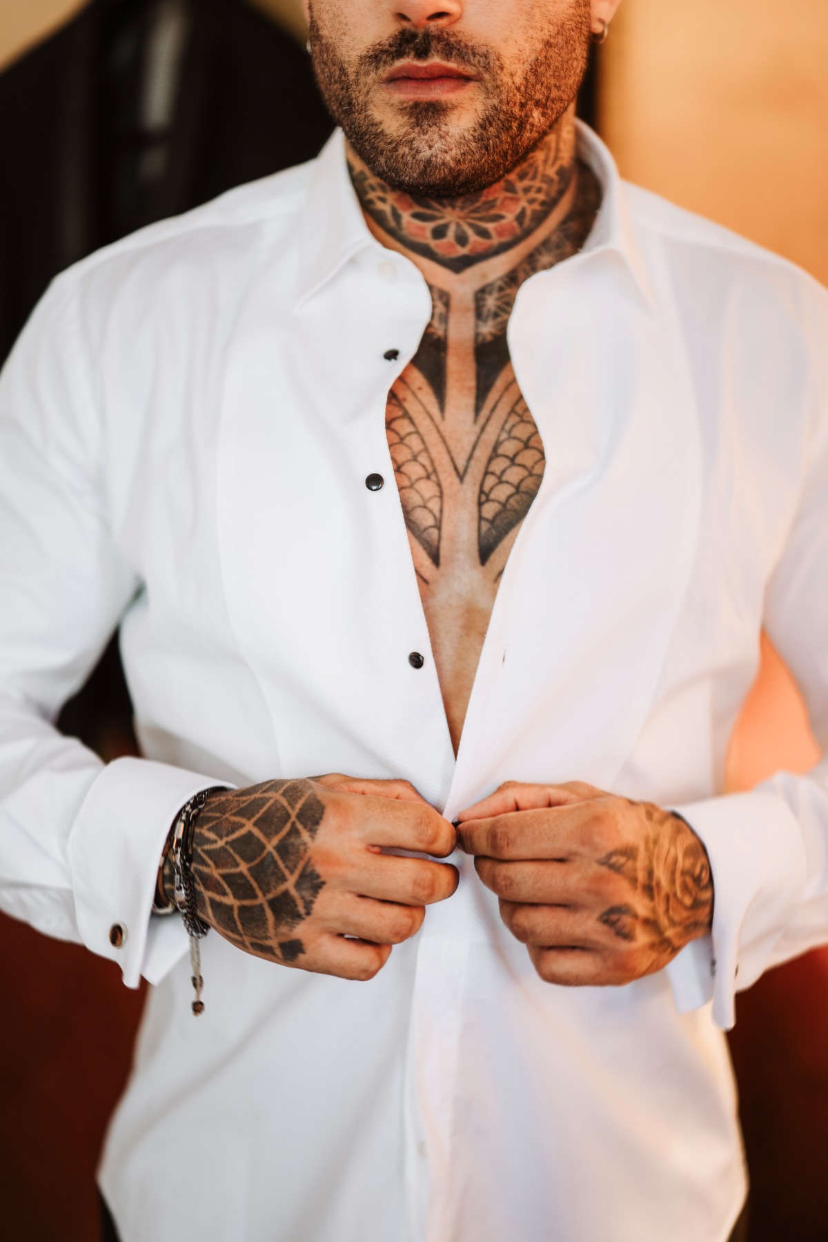 groom getting ready with tattoos