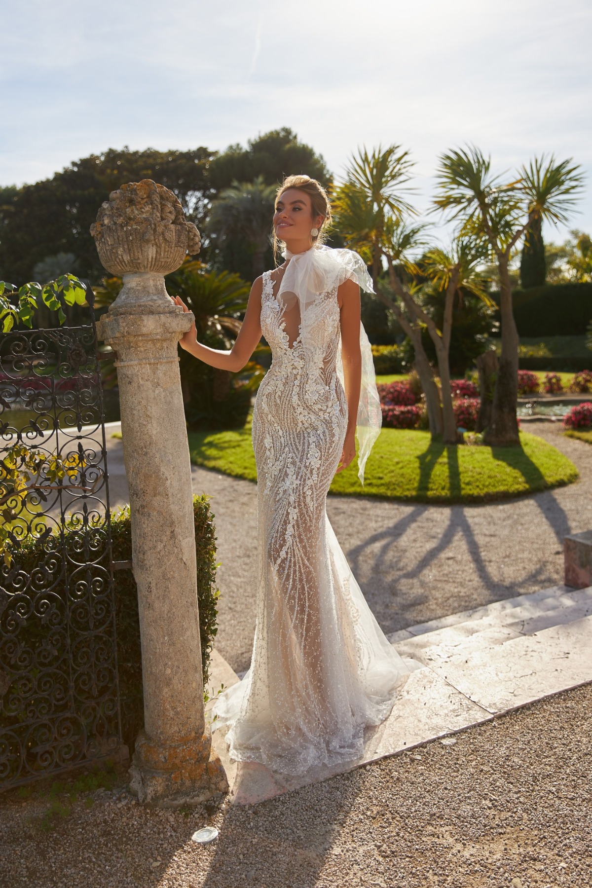 bride wearing beaded wedding gown in luxury garden