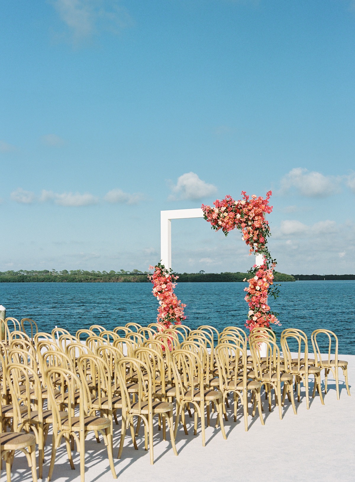 modern pink wedding ceremony on the water