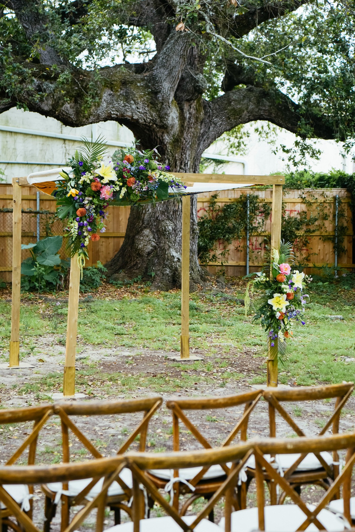 asymmetrical tropical floral wooden arch