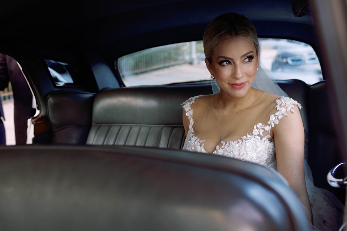 bride in vintage car arriving at wedding ceremony