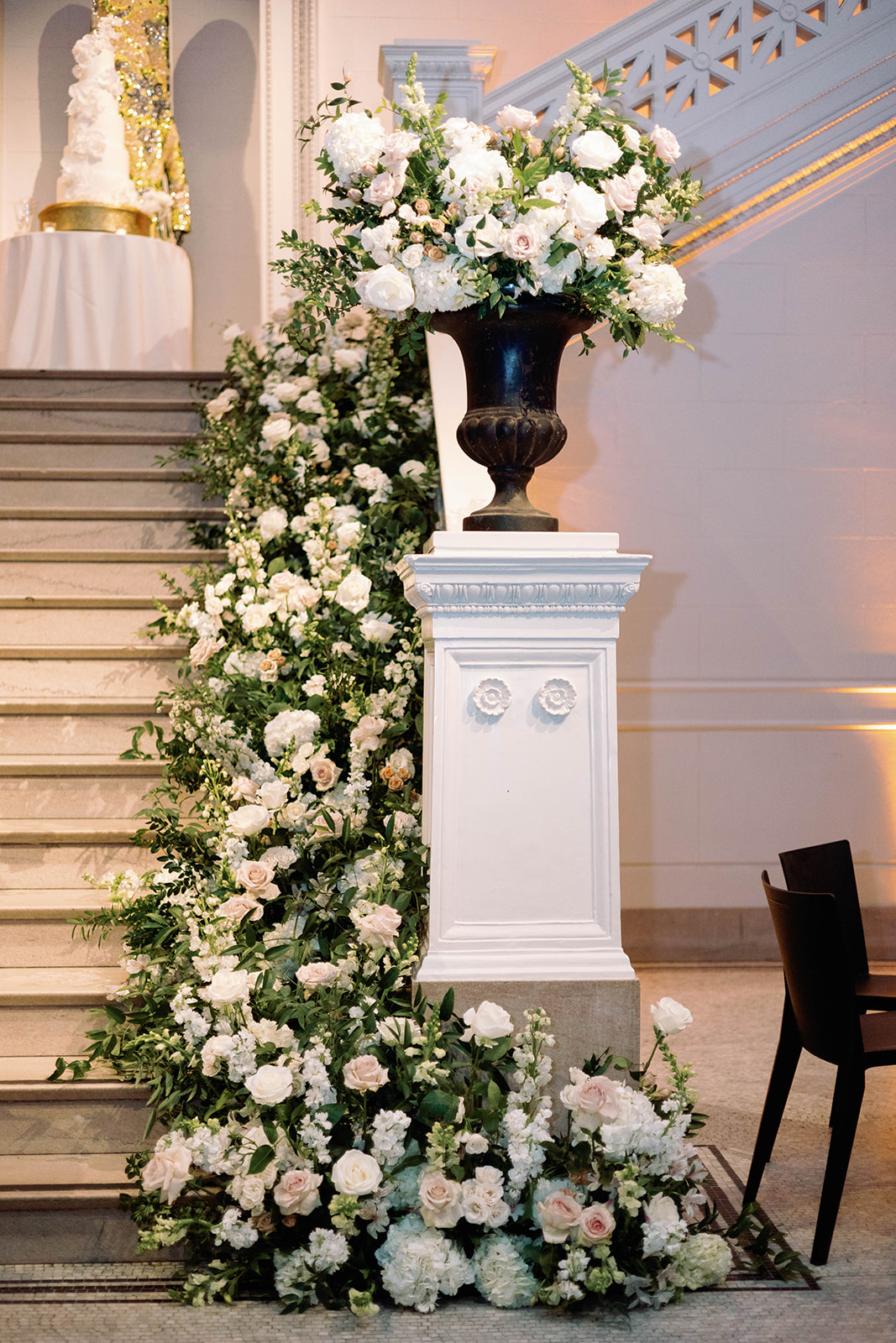 white and blush flower installation on staircase for wedding