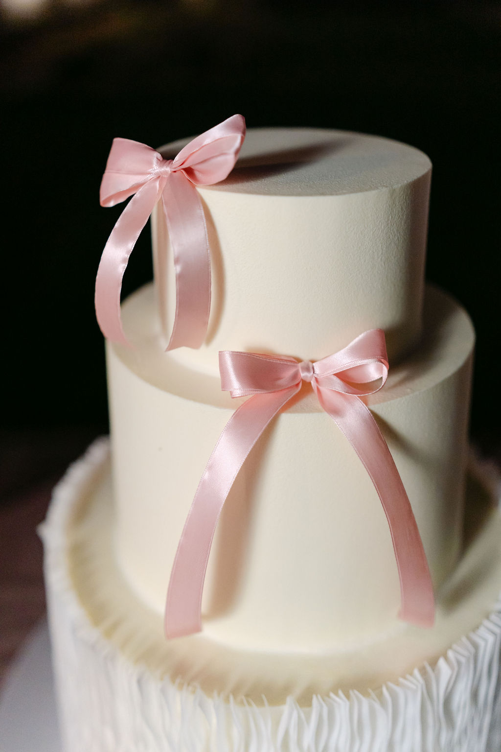 wedding cake with pink bows