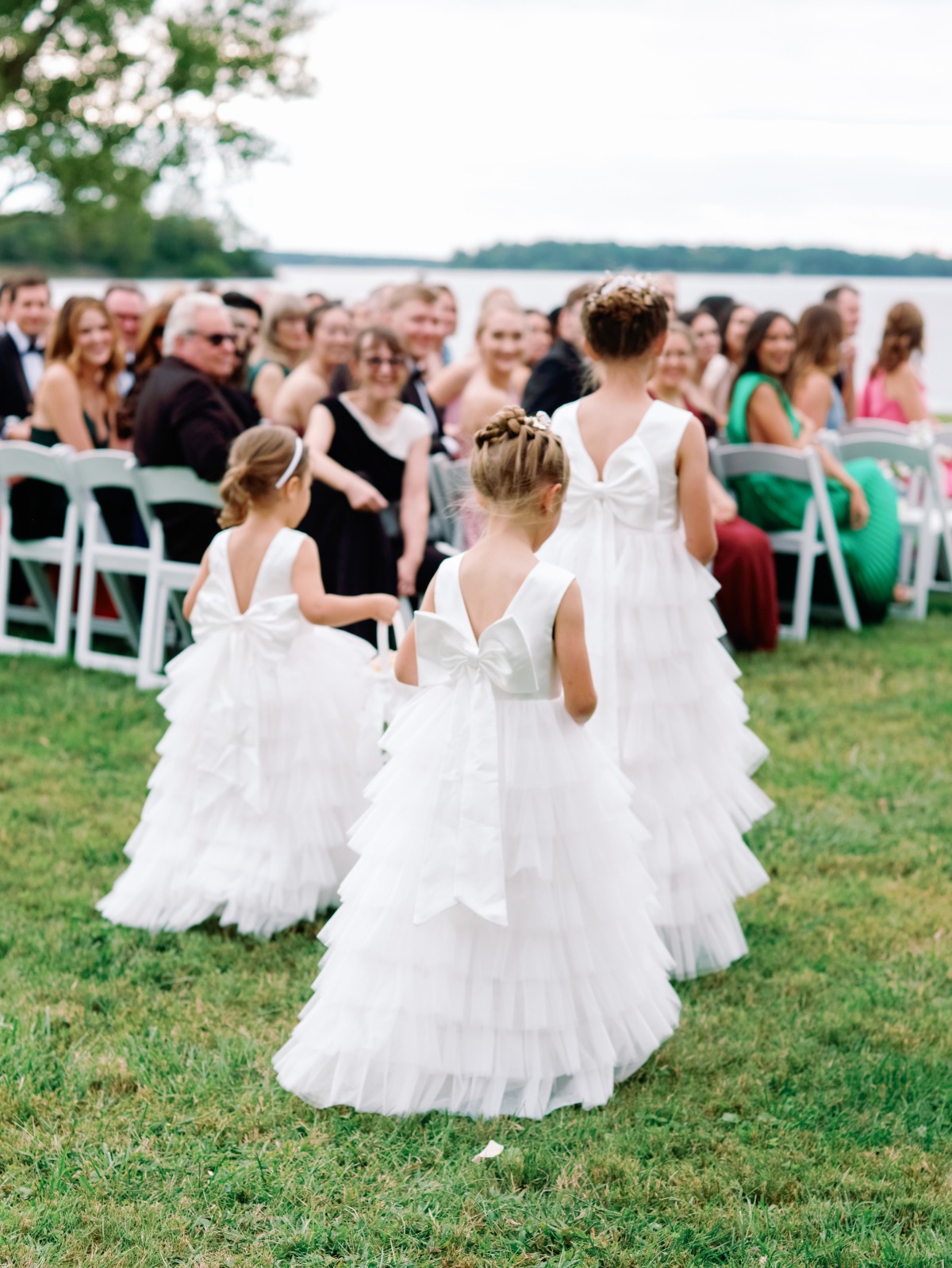 Flower girls walking down lawn