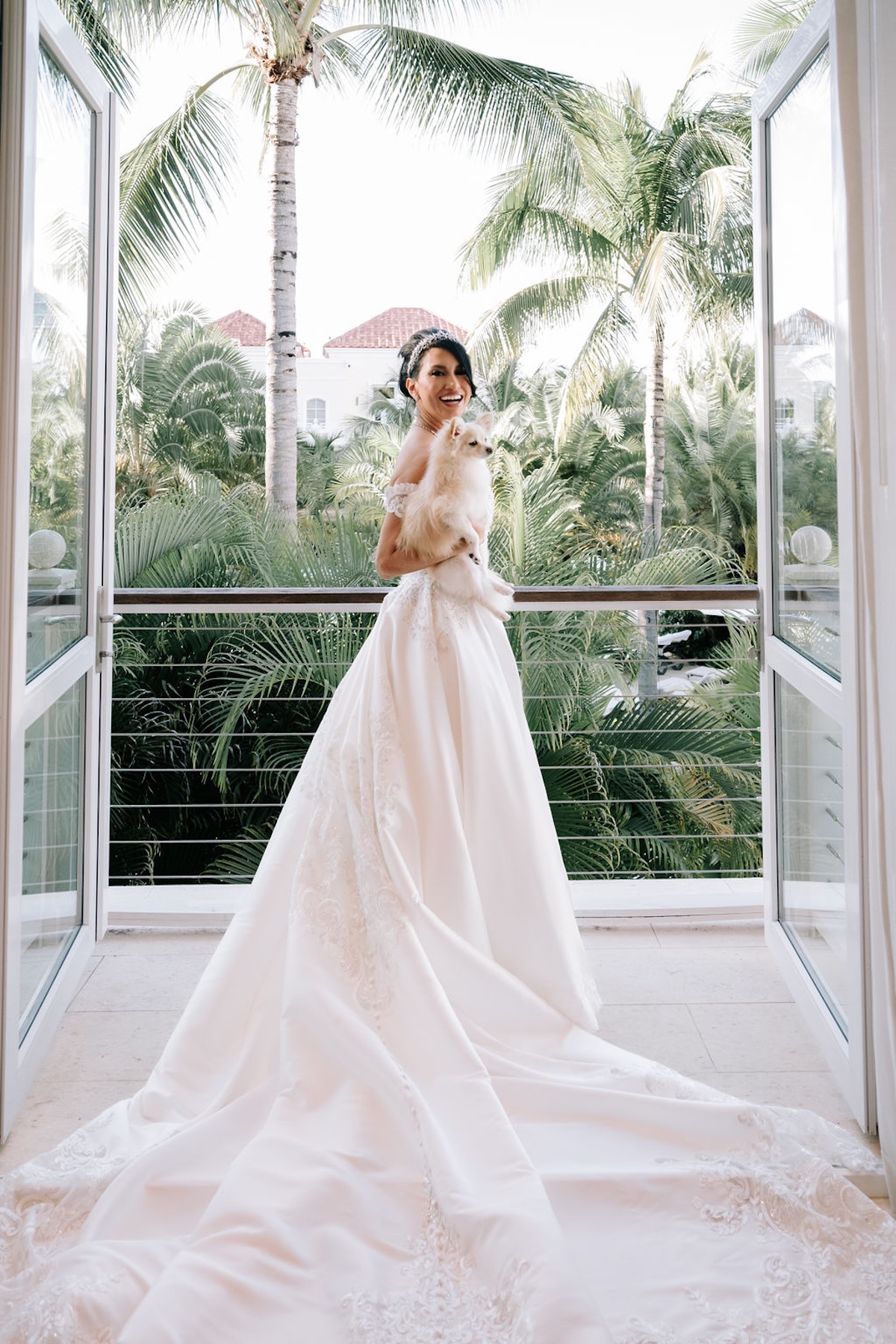 bride posing on balcony with dog