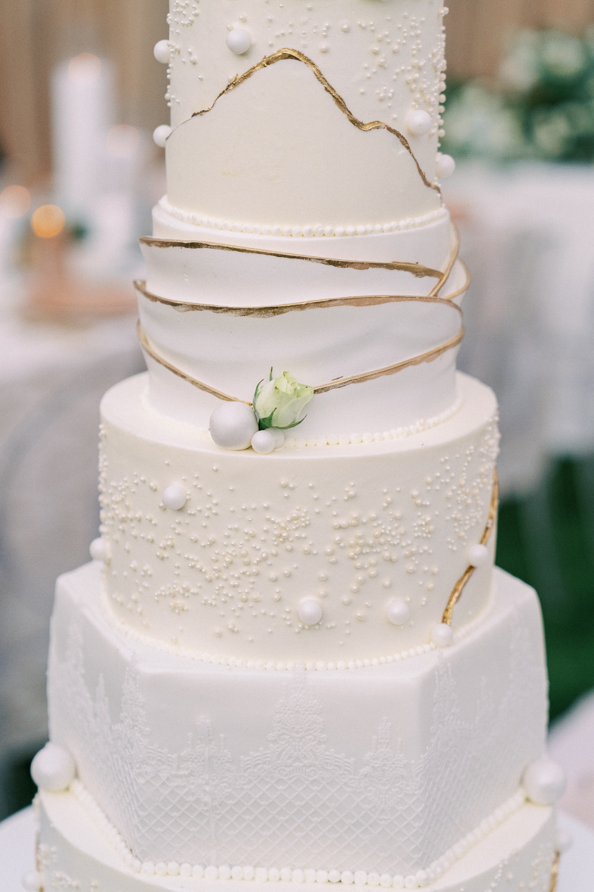 wedding cake with gold foil and pearls