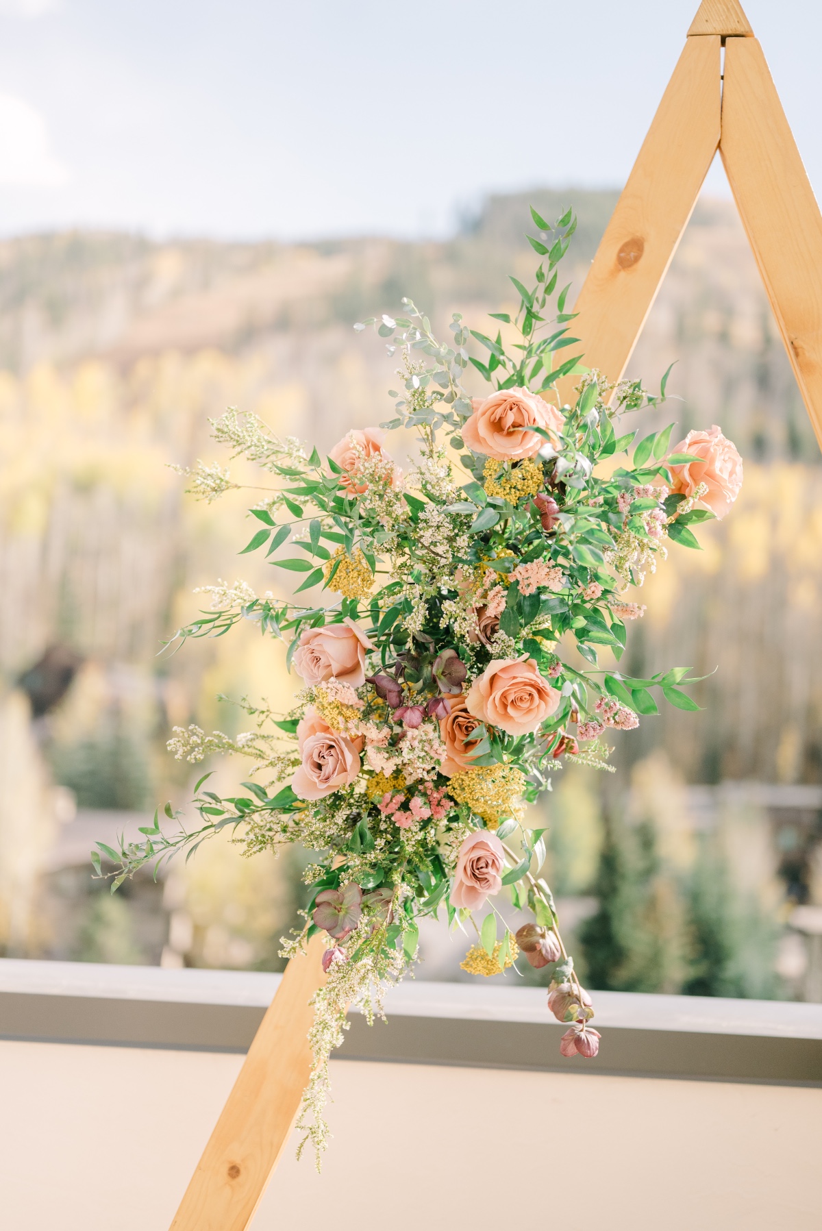 peach yellow and burgundy wedding floral arch ideas