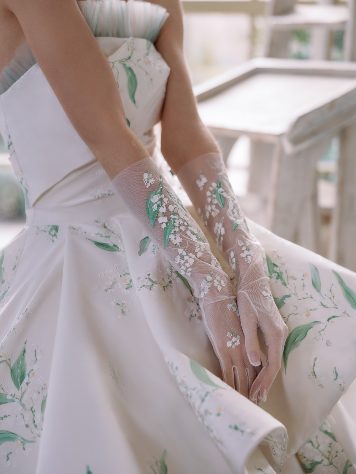 bride wearing garden inspired gloves