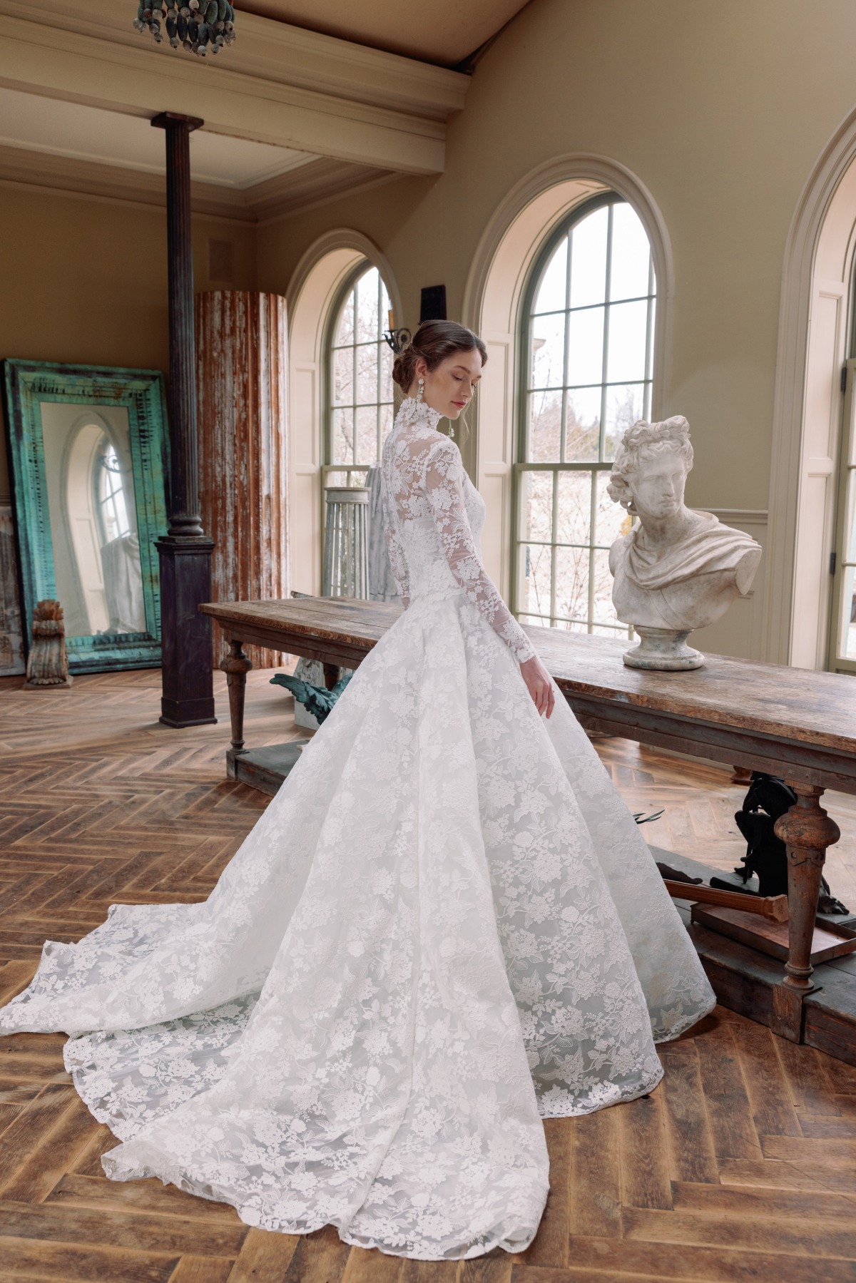 bride wearing long sleeve lace ballgown