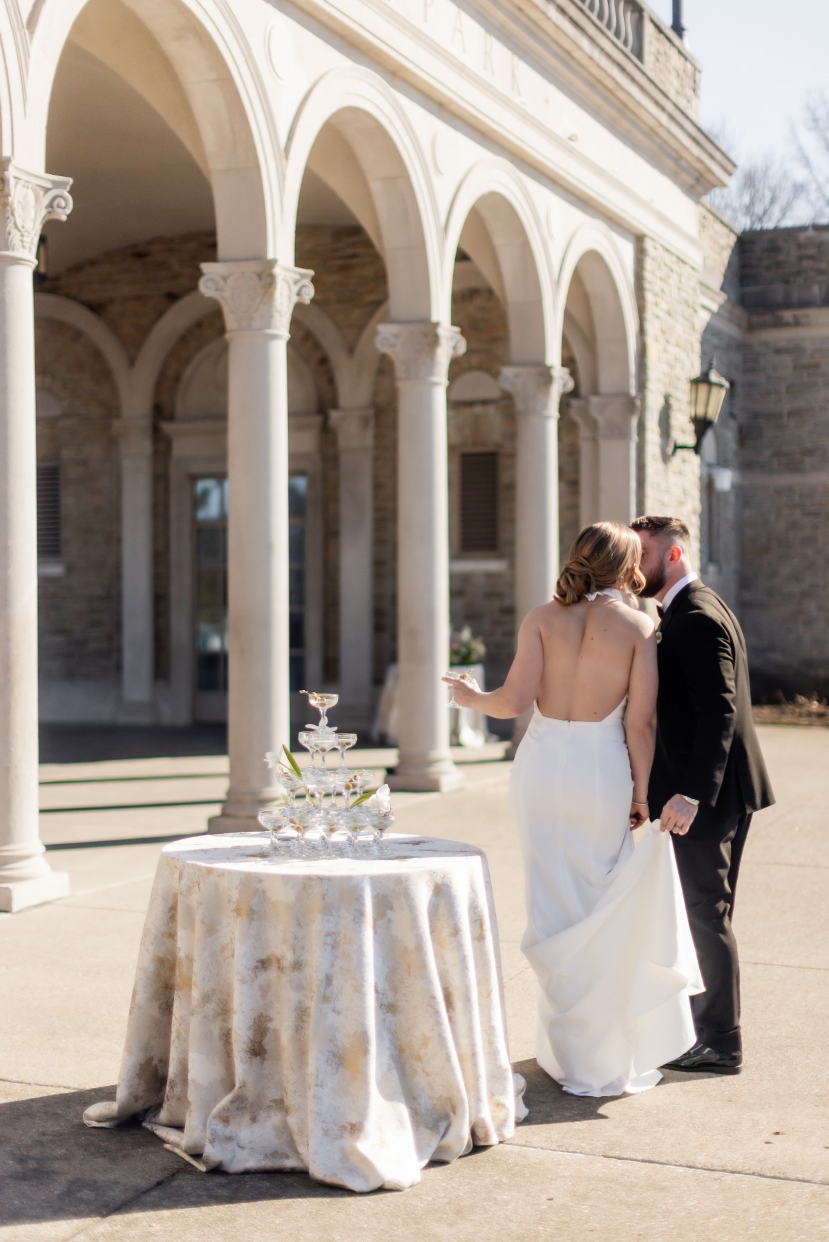 couple kissing in front of champange tower