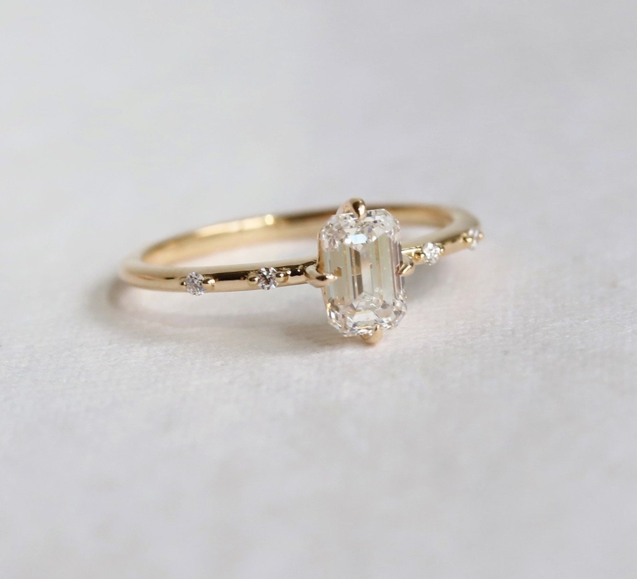delicate emerald cut engagement ring
