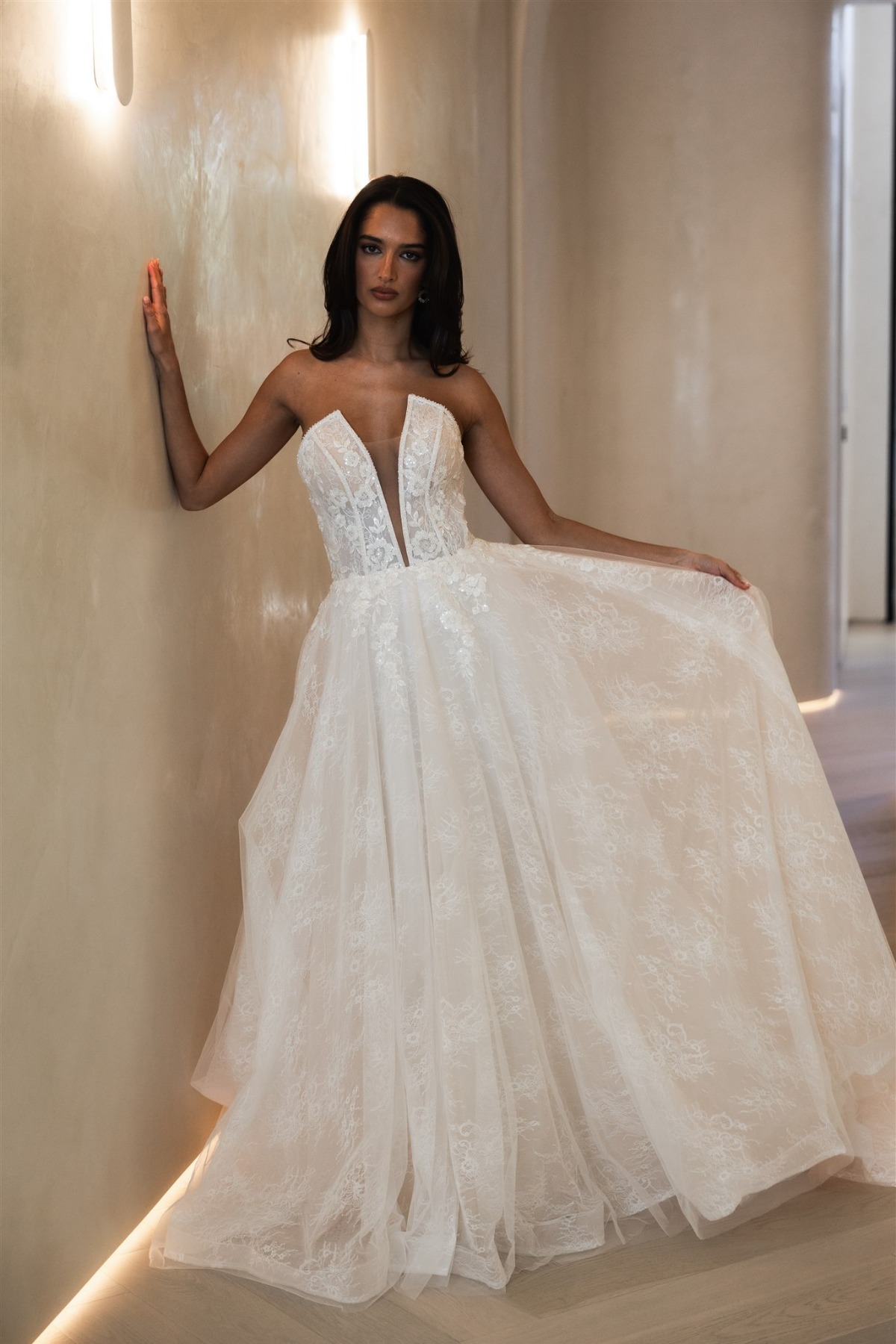 bride wearing unique strapless gown holding the skirt