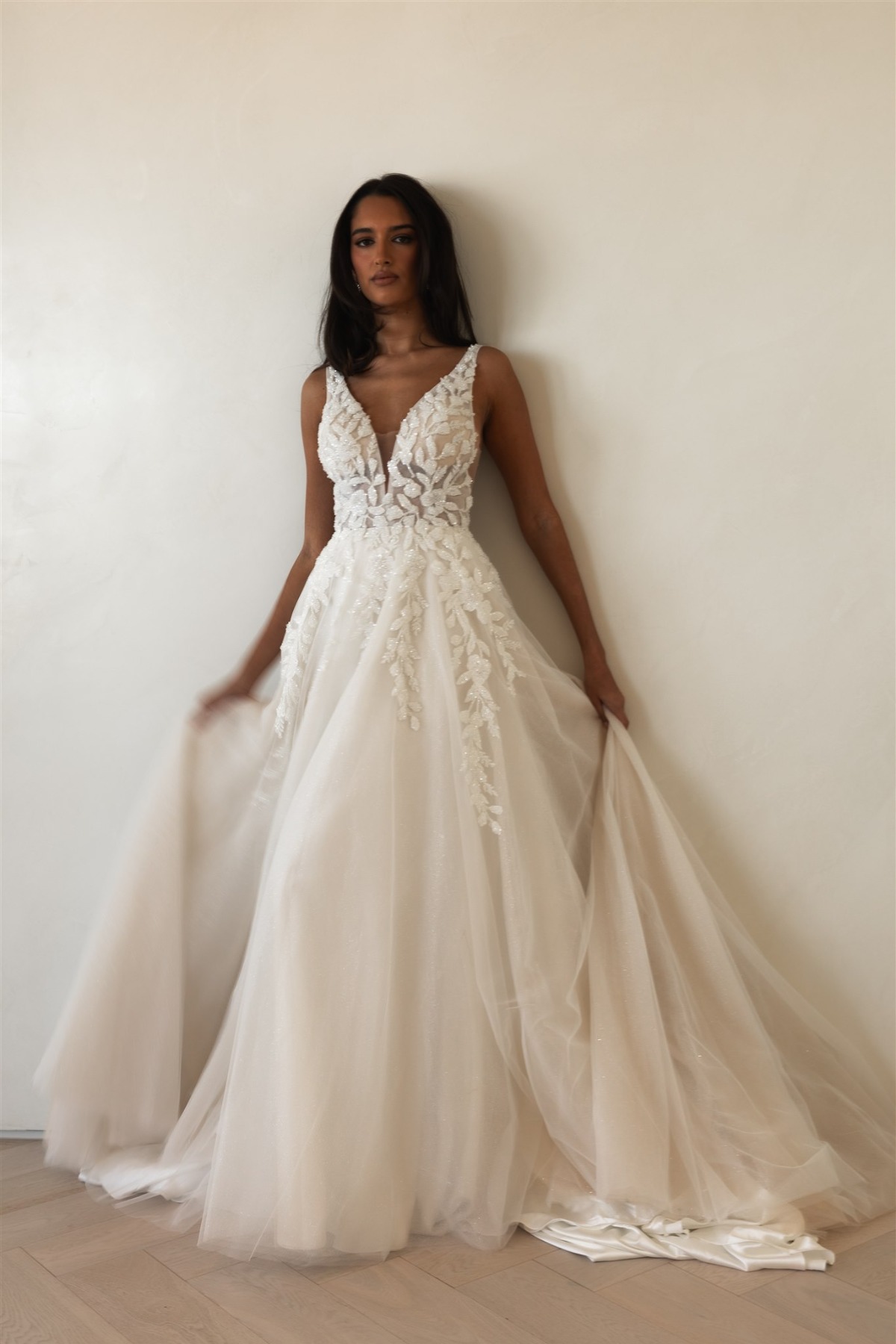 bride wearing tank top wedding dress with plunging neck line