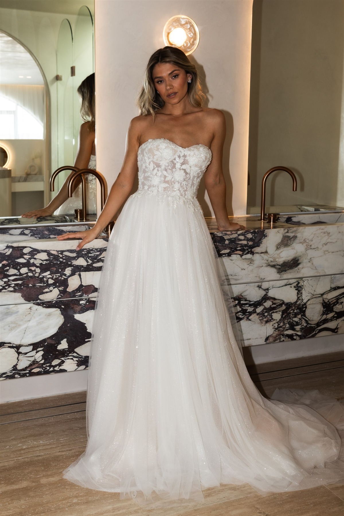 bride wearing strapless wedding dress with floral lace and glitter tulle