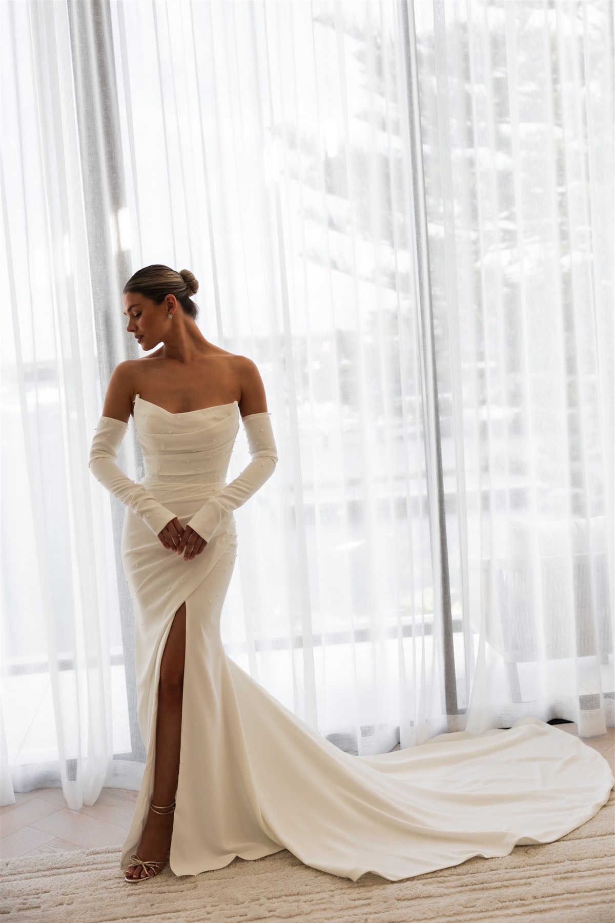 bride wearing sexy wedding dress with leg slit and golves