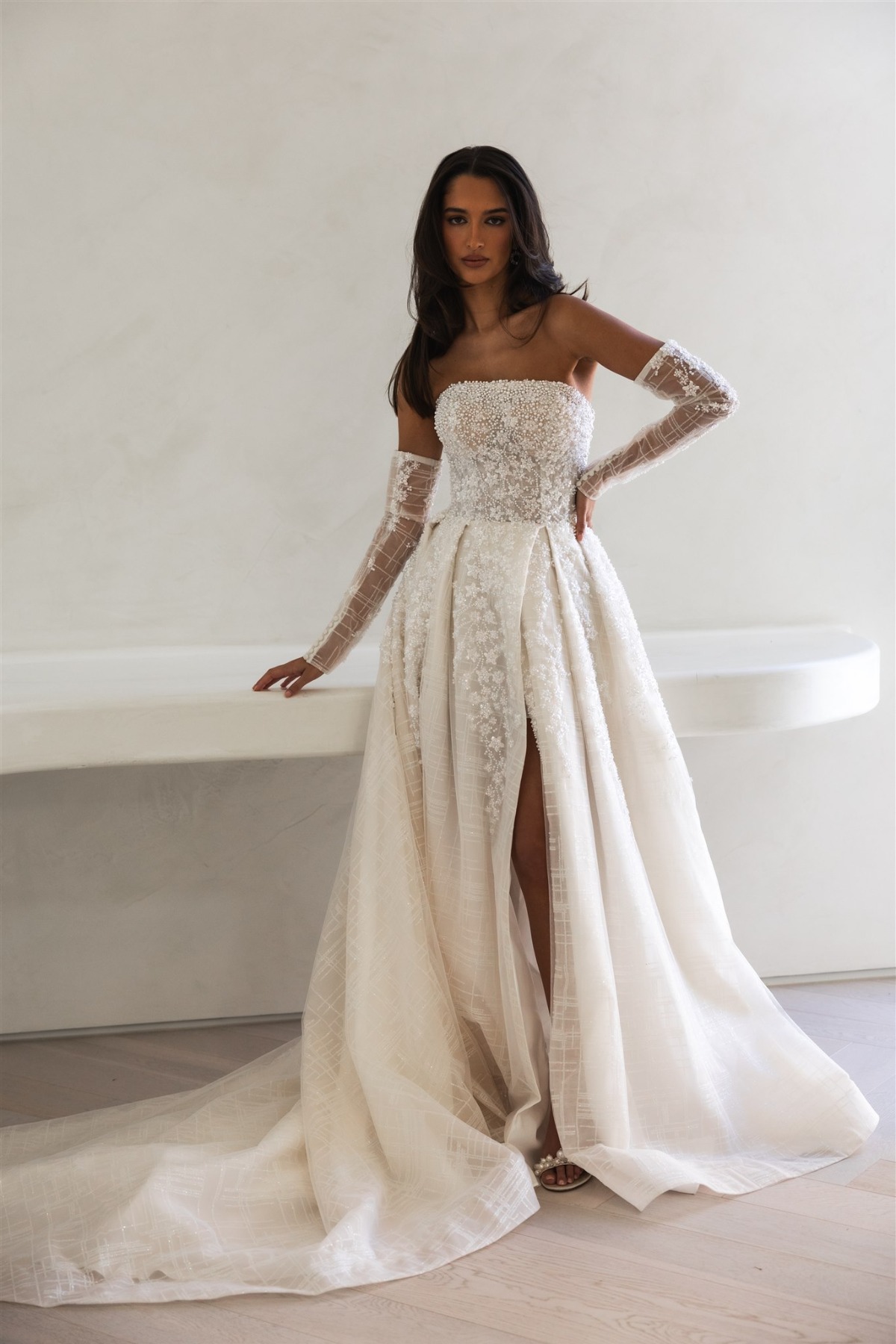 bride wearing strapless floral beaded gown with forearm gloves