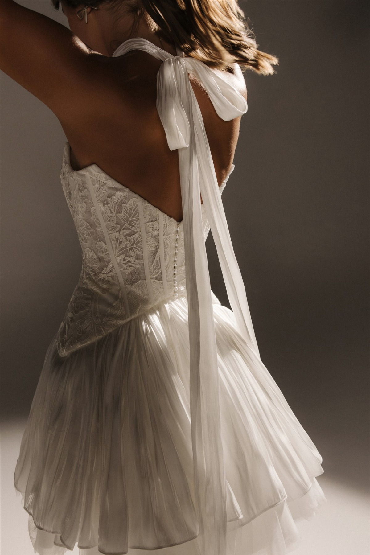 backview of bride wearing lace and bow strapless wedding dress