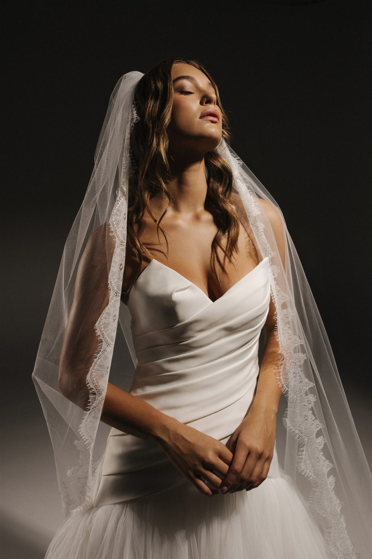 bride in strapless satin gown with veil