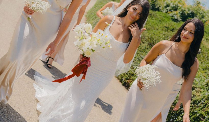 Monochromatic cliffside wedding in Santa Barbara with pop of red