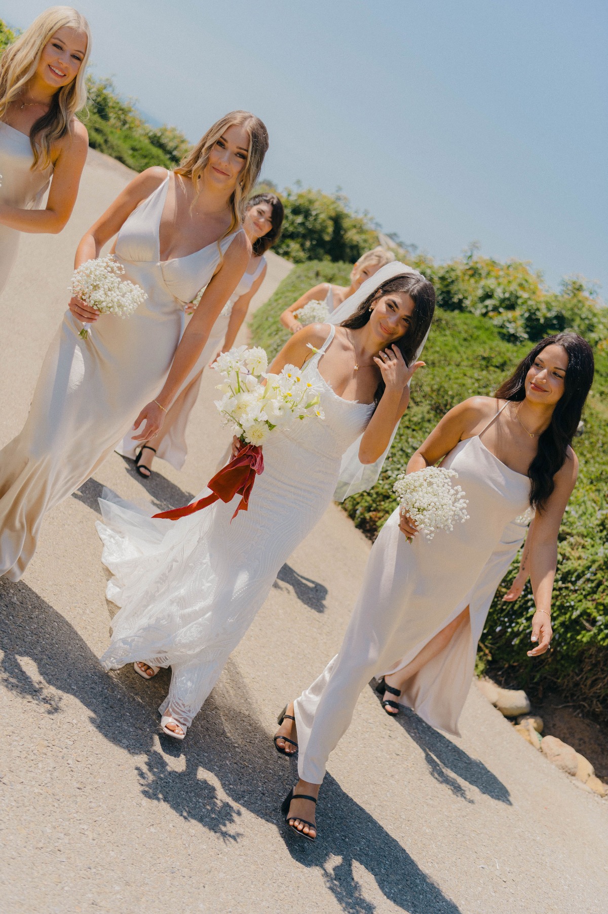 Monochromatic cliffside wedding in Santa Barbara with pop of red